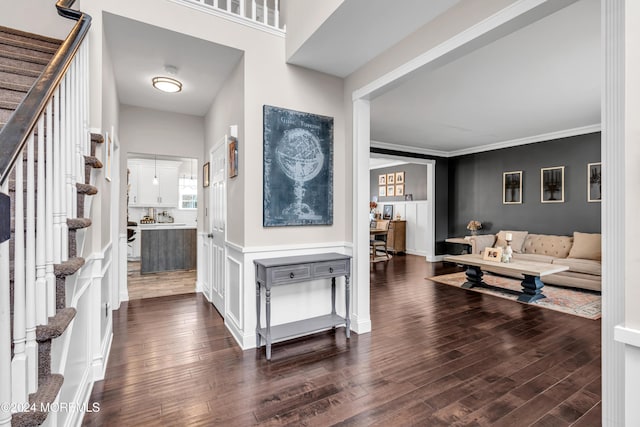 foyer featuring dark wood-type flooring and ornamental molding