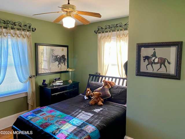 bedroom with hardwood / wood-style flooring and ceiling fan