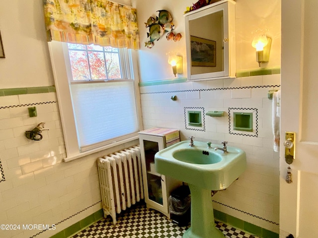 bathroom featuring tile walls and radiator