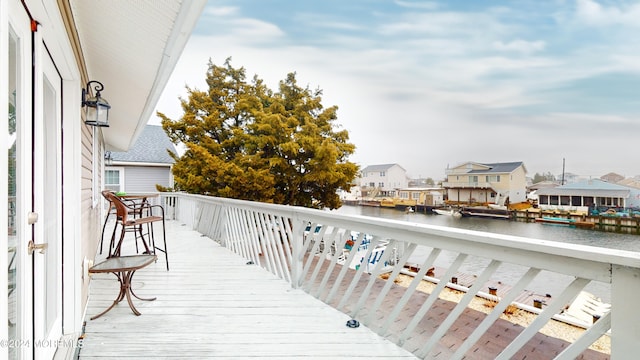 wooden terrace featuring a water view