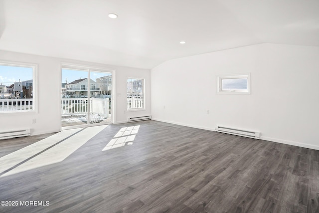 unfurnished living room with baseboard heating, vaulted ceiling, and dark wood-type flooring