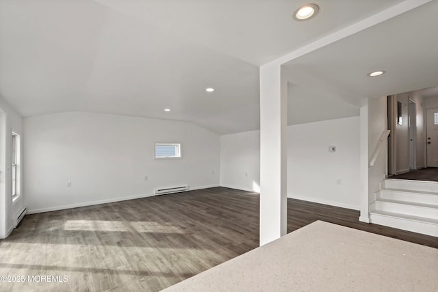 bonus room with a wealth of natural light, dark wood-type flooring, vaulted ceiling, and a baseboard radiator