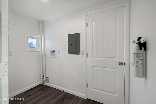 laundry room with washer hookup, electric panel, and dark wood-type flooring