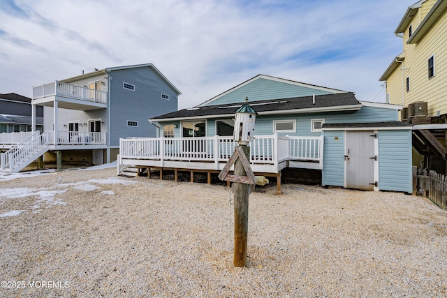 back of property featuring a wooden deck