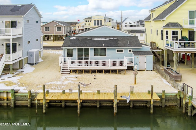 back of house featuring a deck with water view