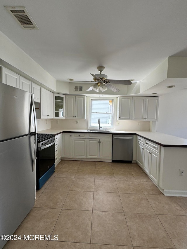 7 Point Rd, Toms River, NJ 08753 - kitchen with appliances with stainless steel finishes, ceiling fan, sink, light tile patterned floors, and white cabinetry