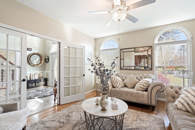 living room featuring wood-type flooring and ceiling fan