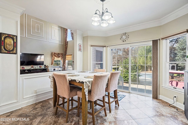 dining area with ornamental molding and a notable chandelier