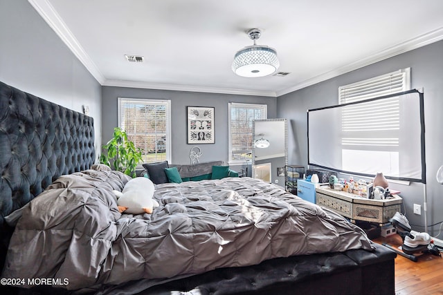 bedroom featuring wood-type flooring and ornamental molding