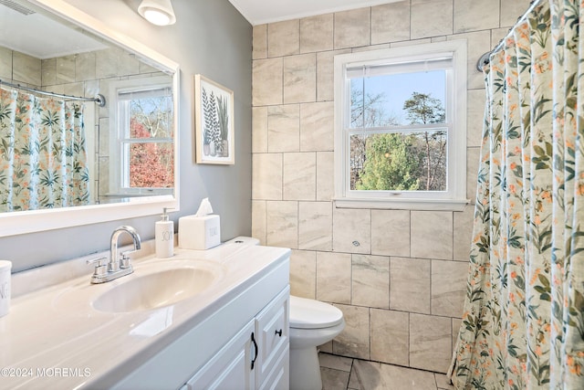 bathroom featuring walk in shower, tile patterned flooring, toilet, vanity, and tile walls