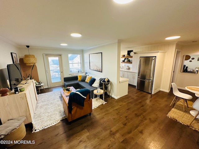 living room with crown molding and dark wood-type flooring