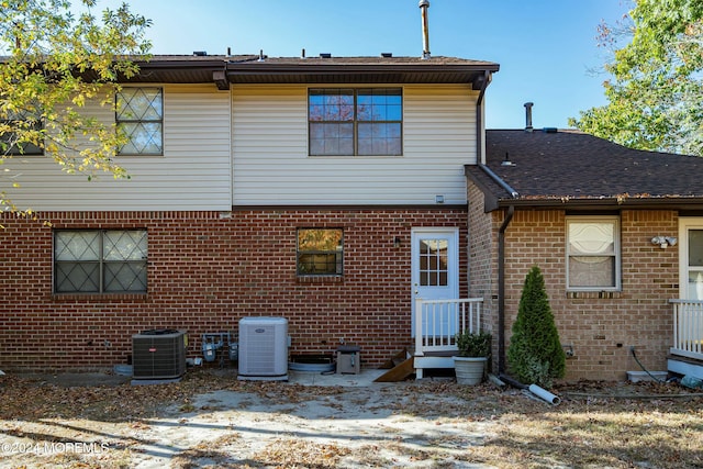 back of house with central AC unit