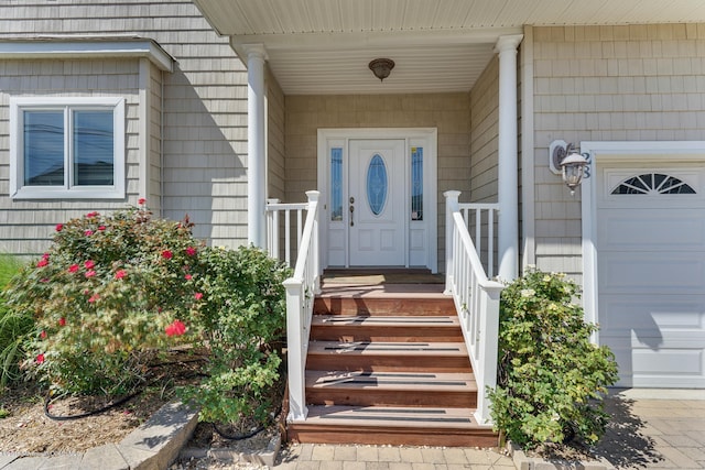 doorway to property with a garage