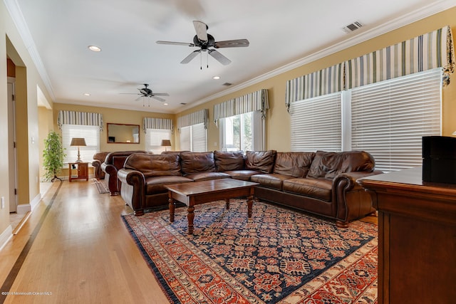 living room featuring ceiling fan, light hardwood / wood-style flooring, and ornamental molding