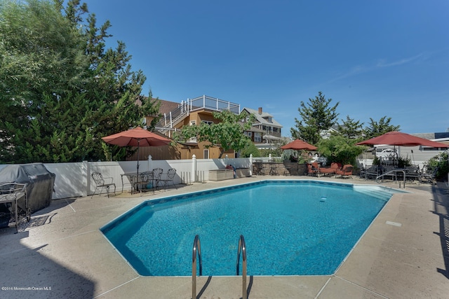 view of pool featuring a patio area and area for grilling