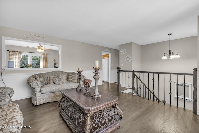 living room with a chandelier and wood finished floors