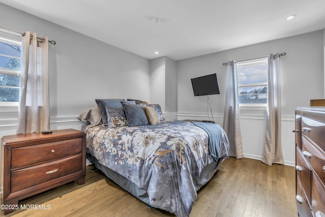 bedroom with light wood-style floors and recessed lighting