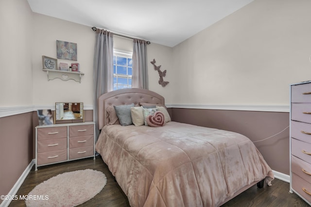 bedroom with dark wood-style floors and baseboards