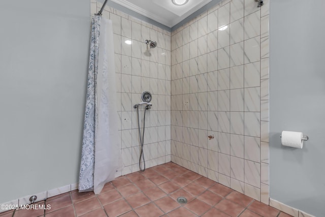 bathroom featuring ornamental molding and a tile shower