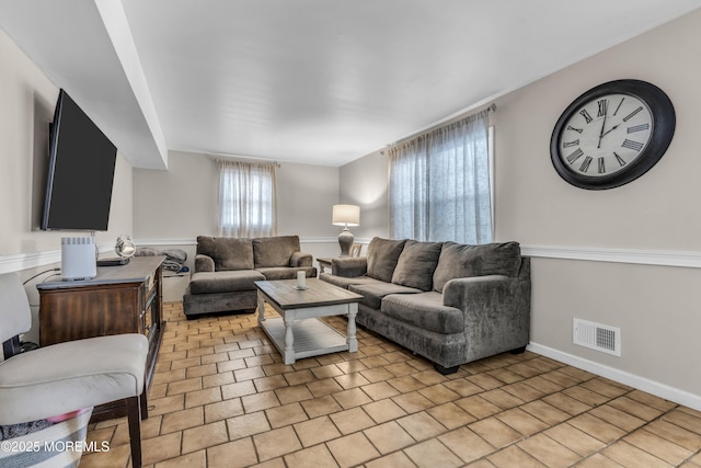 living room with visible vents and baseboards