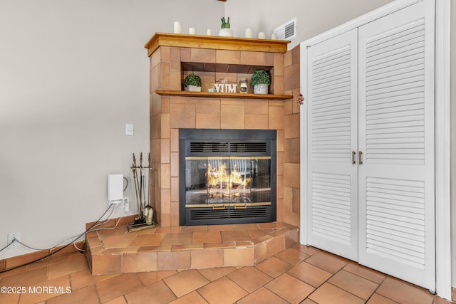 interior details with a tile fireplace and visible vents