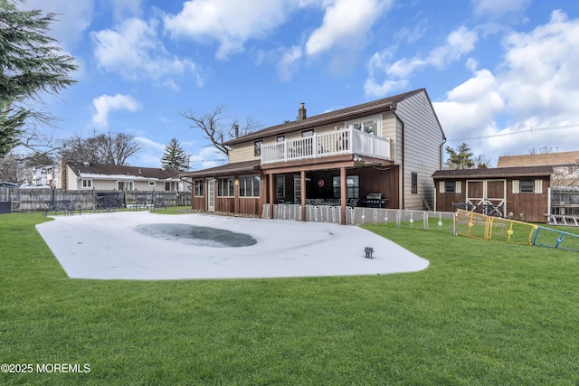 back of house with a patio, a lawn, a chimney, and a fenced backyard