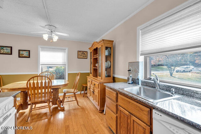 kitchen with white appliances, sink, ceiling fan, light wood-type flooring, and ornamental molding