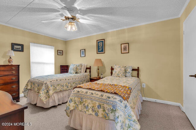 bedroom featuring ceiling fan, light colored carpet, a textured ceiling, and crown molding