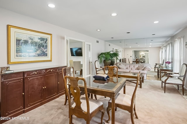 dining room featuring light colored carpet