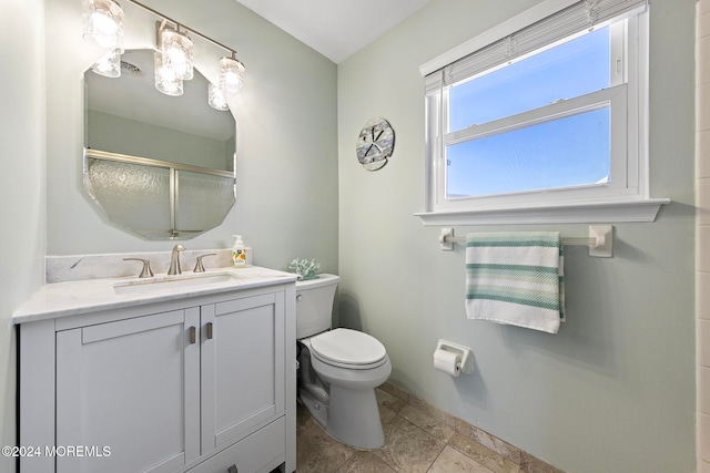 bathroom with vanity, toilet, and walk in shower