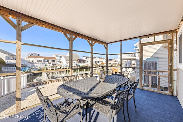 sunroom / solarium with a wealth of natural light and a water view