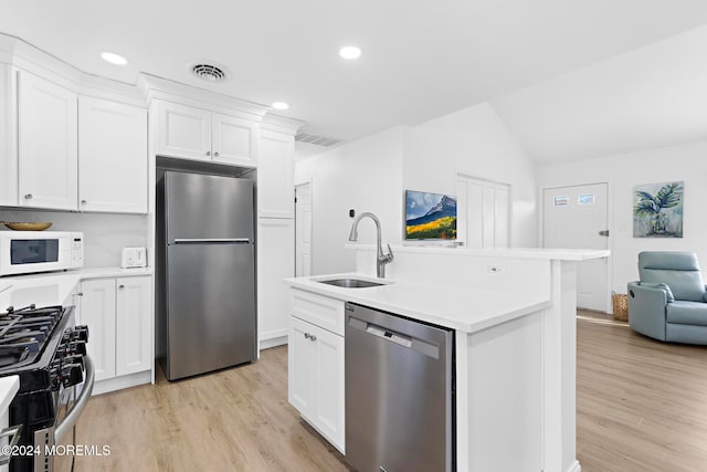 kitchen with white cabinets, stainless steel appliances, light hardwood / wood-style flooring, and sink