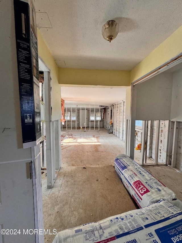 hallway featuring a wealth of natural light and a textured ceiling