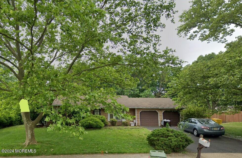 view of front of home with a front yard and a garage