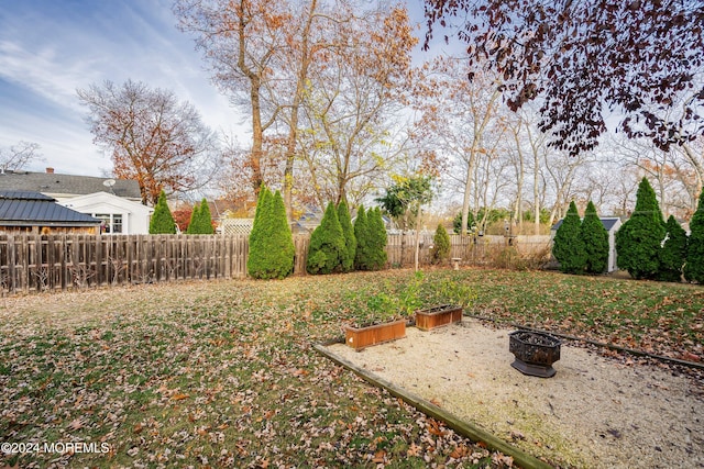 view of yard with an outdoor fire pit