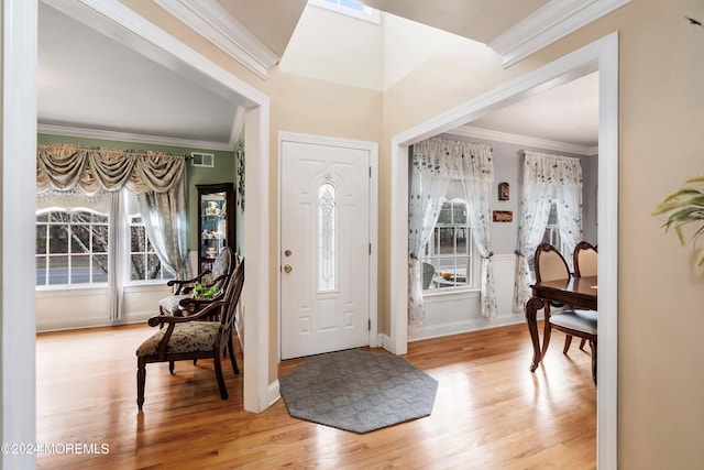 entryway with crown molding and light wood-type flooring