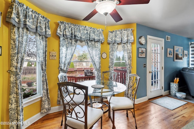 dining space featuring a wealth of natural light, ceiling fan, and hardwood / wood-style flooring