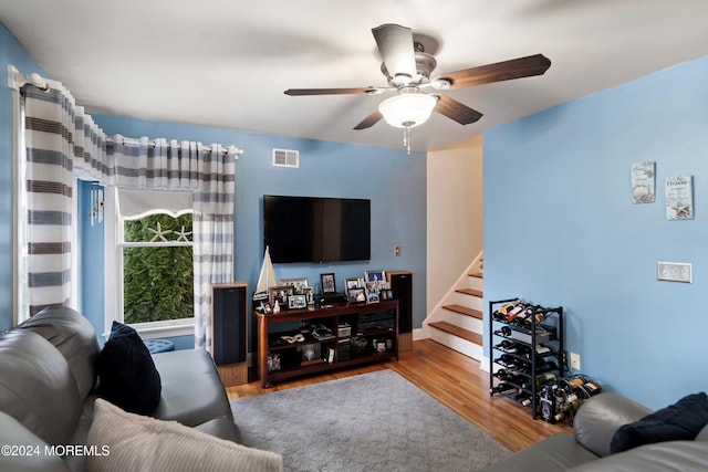 living room with ceiling fan and light hardwood / wood-style floors