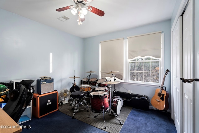 miscellaneous room with ceiling fan and carpet