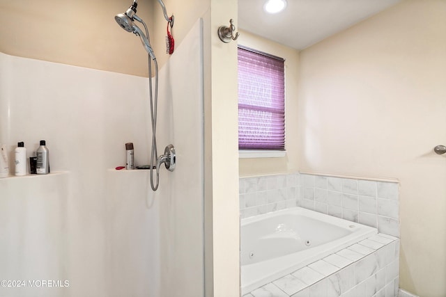 bathroom with a relaxing tiled tub