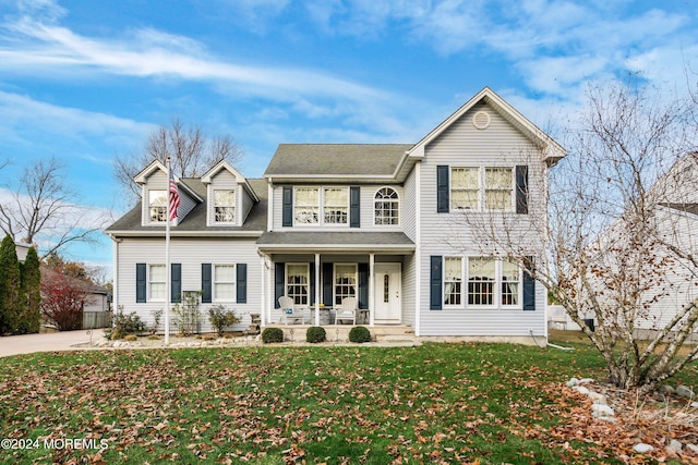 view of front of property with a porch and a front lawn