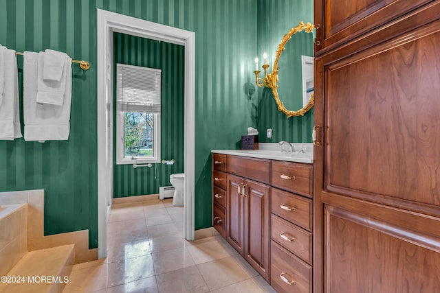 bathroom with tile patterned floors, vanity, toilet, and baseboard heating