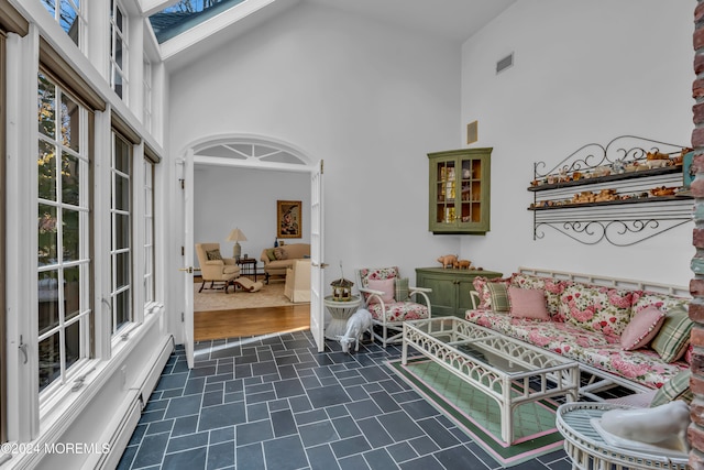 interior space with high vaulted ceiling and dark wood-type flooring