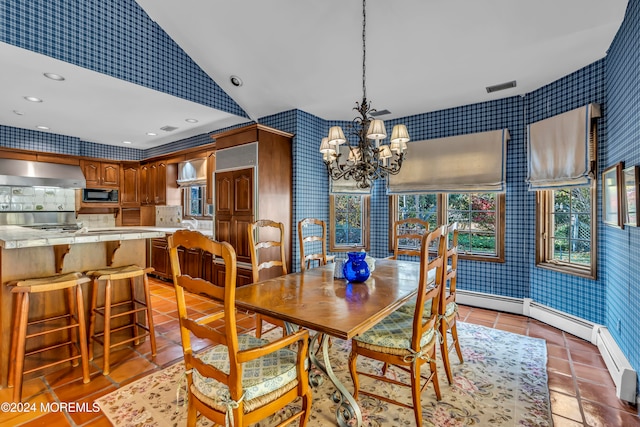 dining area with light tile patterned floors, vaulted ceiling, and an inviting chandelier