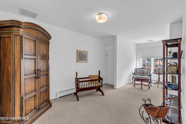 sitting room with light colored carpet and a baseboard heating unit