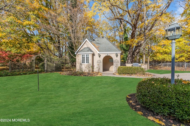 view of outbuilding featuring a lawn