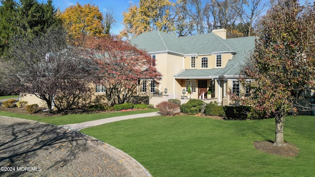 view of front facade featuring covered porch and a front lawn