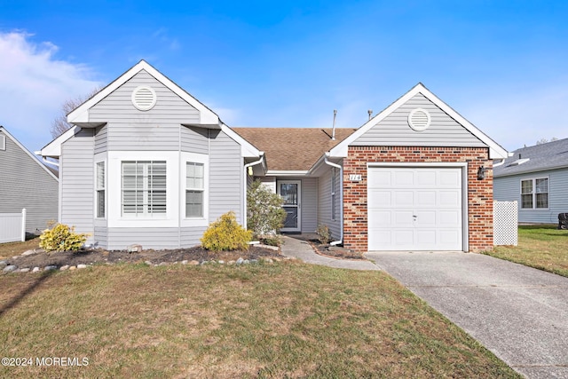 view of front of property with a garage and a front yard