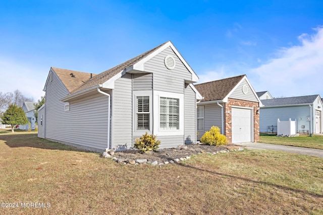 view of front of property with a front lawn and a garage