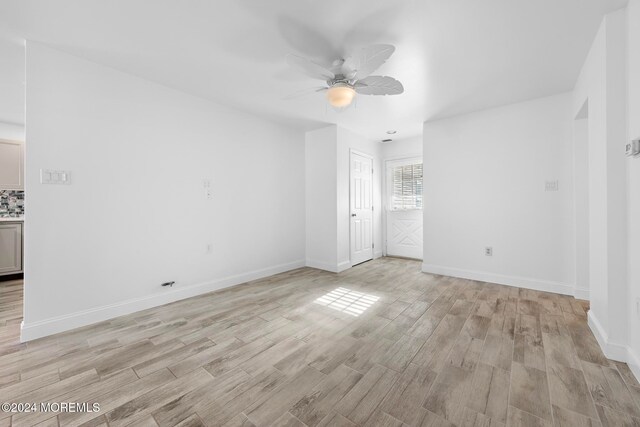 spare room with ceiling fan and light hardwood / wood-style floors